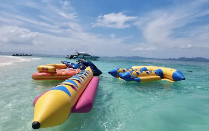 Inflatable banana boats floating on clear shallow water