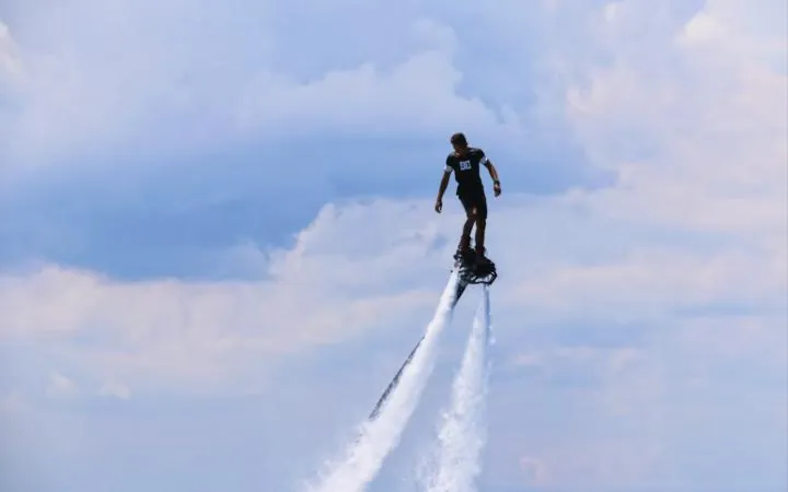 Flyboarder lifted high above the water on twin jets